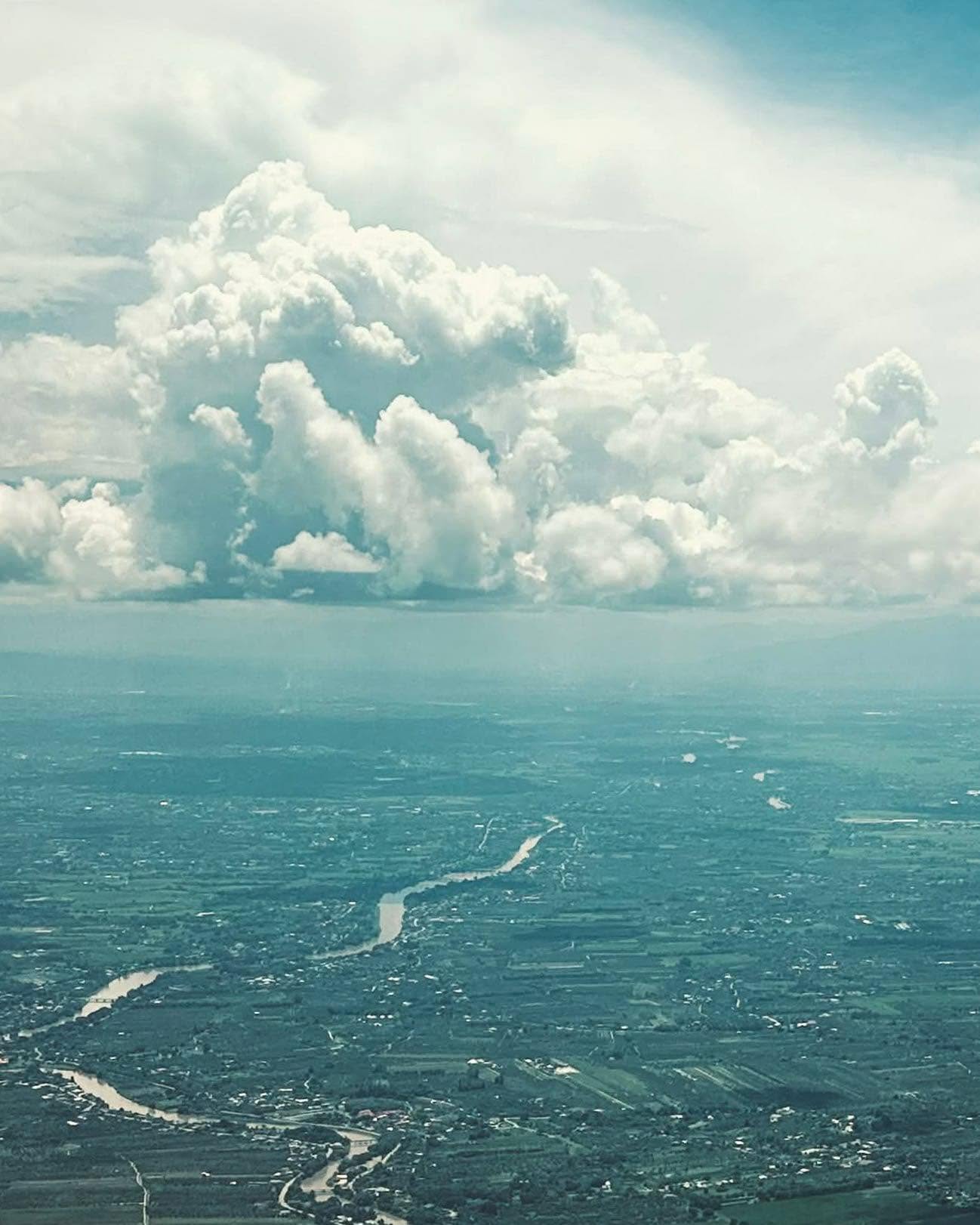 Aerial view of towering cumulus clouds over Chiang Mai, Thailand, Ping River.